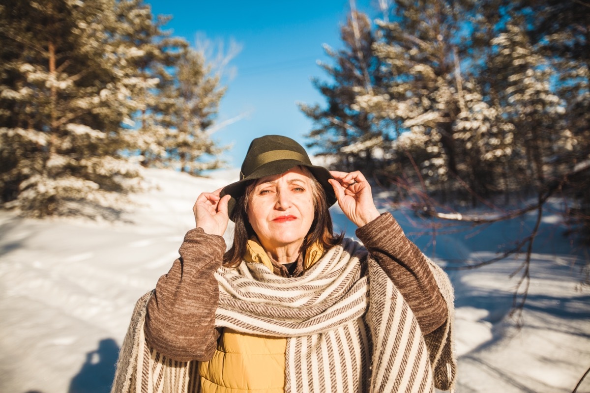 woman wearing vest hat and scarf