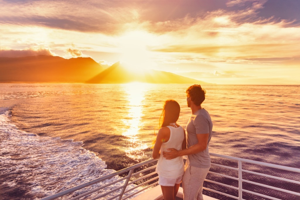 Couple on a cruise looking out at the sunset