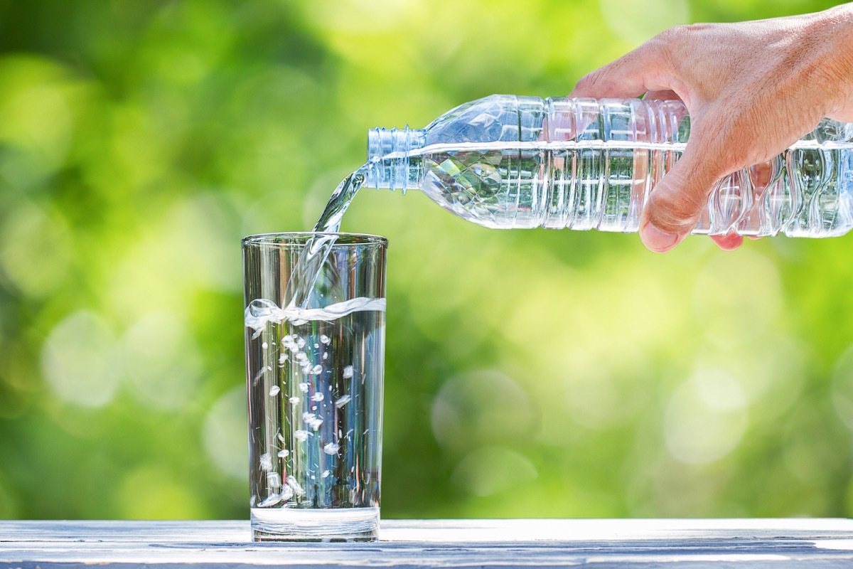 bottled water pouring into glass