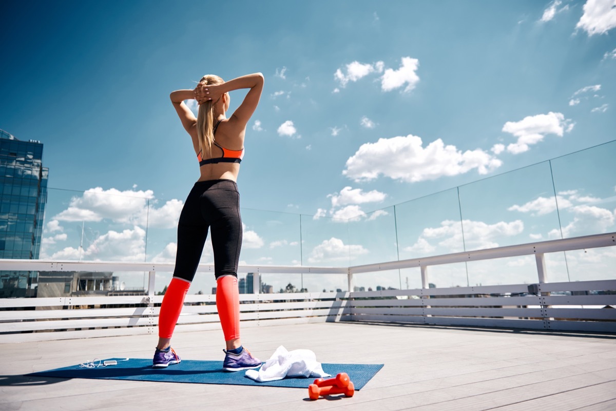 Woman standing working out outside