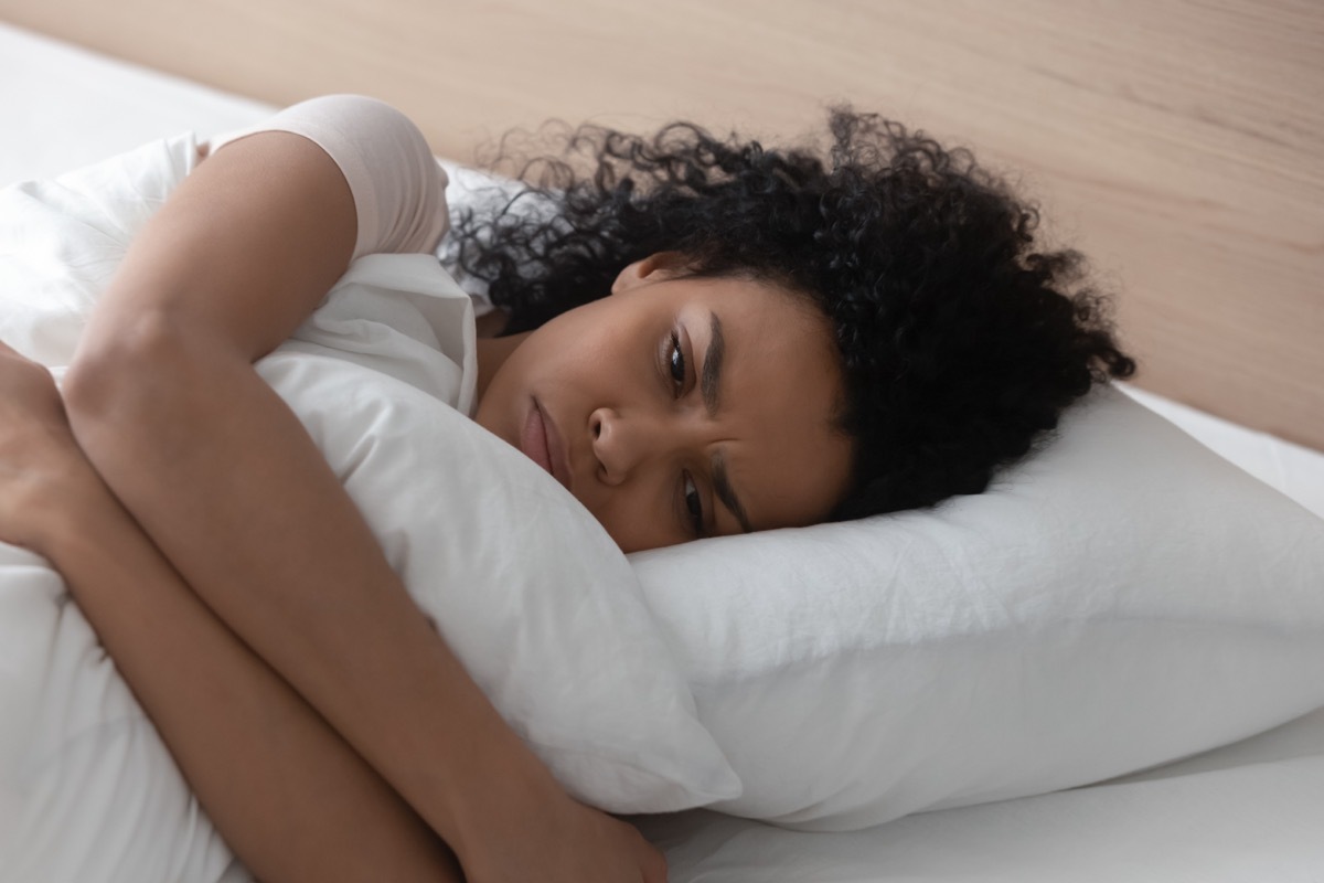 unhappy woman hugging a pillow