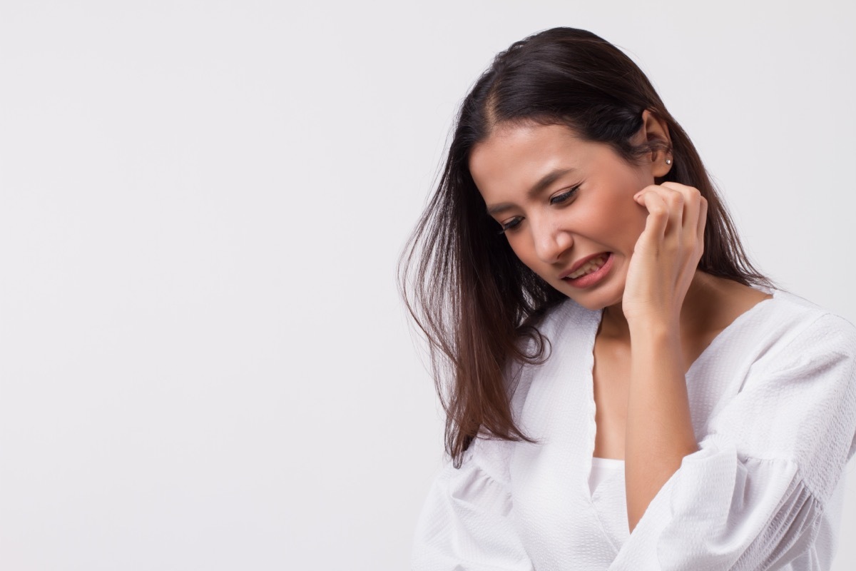 woman scratching her face