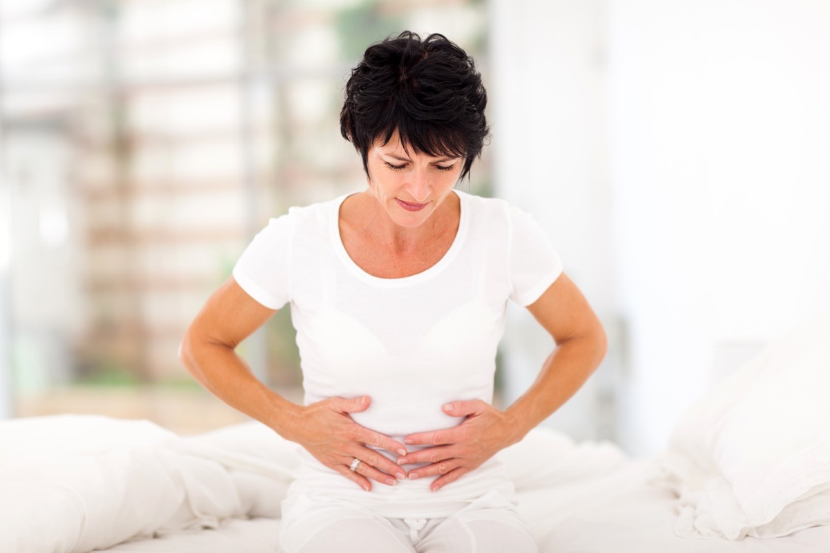 Woman clutching her stomach in pain